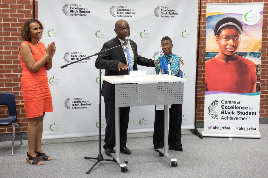 System Superintendent Jacqueline Spence, Trustee Smith and System Superintendent Karen Murray stand at podium. Open Gallery